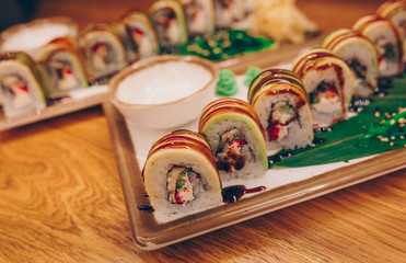 Close-up Set Philly california avocado eel smoked Red Green dragon California ,Ebi Roll philadelphia rolls assorti ginger seaweed in night dining restaurant. Delicious Sushi rolls served in a bar.