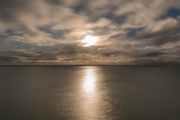 Long exposure of the sun, clouds and the sea in England, UK.