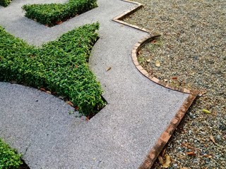 The terrazzo floor in the park is decorated with beautiful green plants.