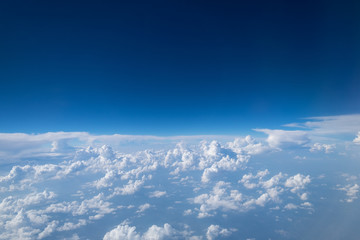 Naklejka na ściany i meble Blue sky with clouds Top view from the airplane window, Natural cloudscape for copy space.