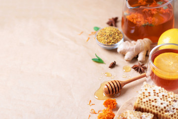 Autumn harvest concept. Set of honey and bee products, apple, lemon, spices on craft paper background. Immune system support with alternative medicine