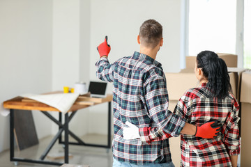 Happy couple planning design of their new house, back view