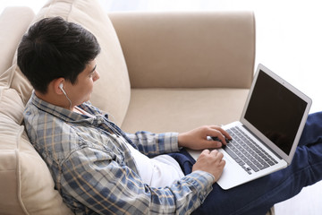 Asian student with laptop preparing for exam at home