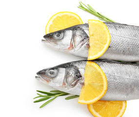 Fresh seabass fish with rosemary and lemon on white background
