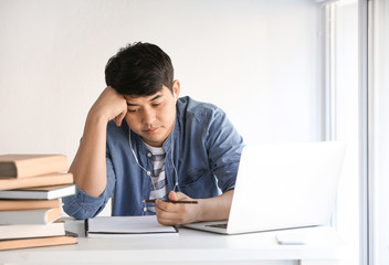 Asian student preparing for exam at home