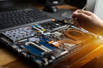 Fototapeta na wymiar Technician repairing broken laptop notebook computer