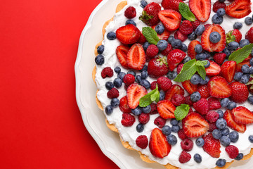 Tasty berry pie on color background