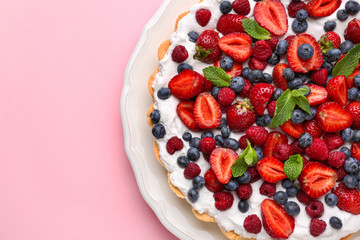Tasty berry pie on color background