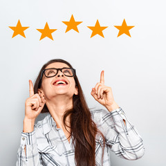 The best rating, evaluation. Business confident happy woman voting the hand on five yellow star to...