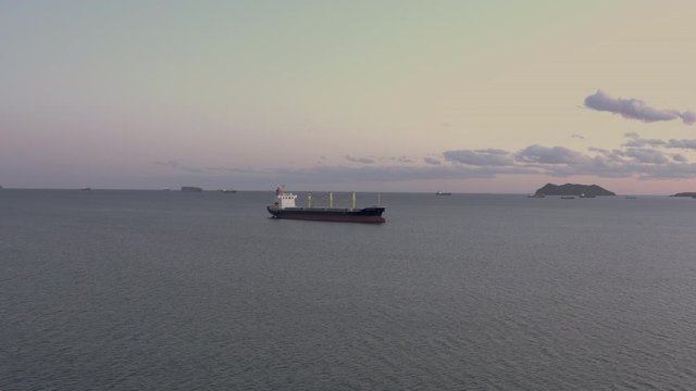General cargo ship at the anchorage in the evening, Far East, Russia