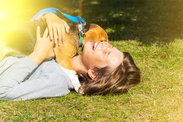 teen girl with dog, dog licks her face.
