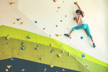 Woman in boulder gym. - obrazy, fototapety, plakaty