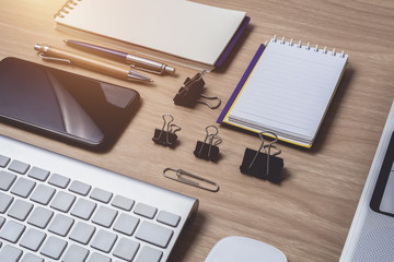 Workspace with diary or notebook and clipboard, laptop, mouse computer, keyboard, smart phone, pencil, pen on wooden background