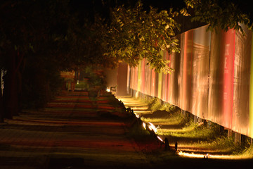pedestrian foot path lit by flood lights early in the morning