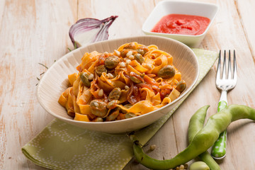fettuccine pasta with broad bean tomato and pine nuts