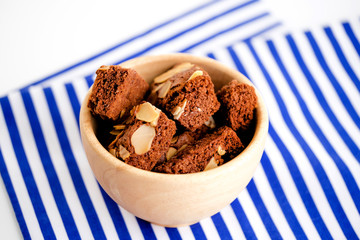Homemade brownies chocolate with nut on wood plate on minimal style background