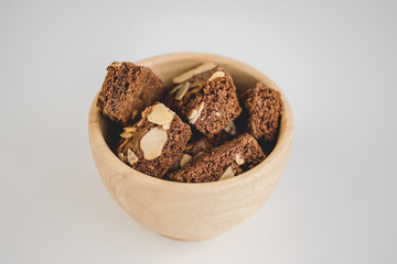Homemade brownies chocolate with nut on wood plate on minimal style background
