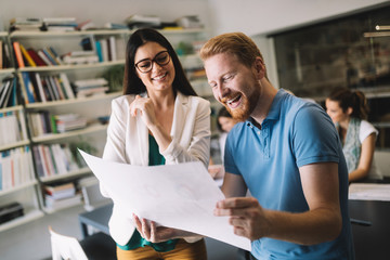 Team of colleagues brainstorming together while working in modern office