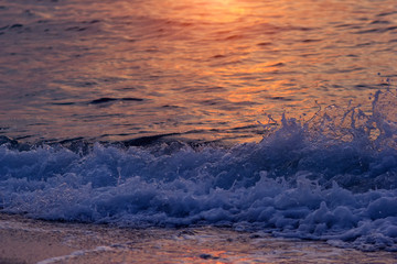 Evening sea waves on beach. Dusk sunlight on summer sea vacation.