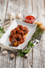 meatball with tomatoes sauce filled with potatoes