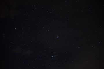 Stars in the night sky overhead. Night starry sky over the mountains. Stars and constellations in the sky.