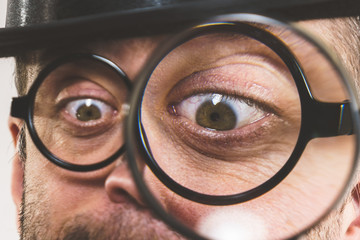 Funny man with magnifying glass