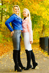 Females wearing fashionable autumn outfits