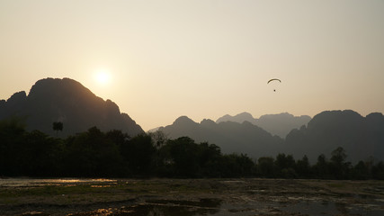 Sunset over the river with mountains in the background in Vang Vieng, Laos, Southeast Asia.