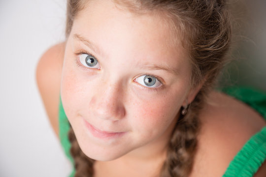 portrait of a caucasian young girl 10 years old with beautiful blue eyes close-up.