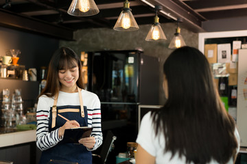 Young asian women barista get orders at the coffee shop,start up small business owner food and drink concept.