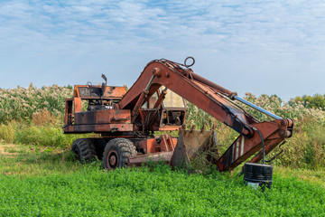 Abandoned broken old rusty excavator. Forgotten technics.