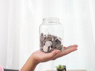 Pile of silver coins,Piggy bank,Money on hand,Background,Business,White