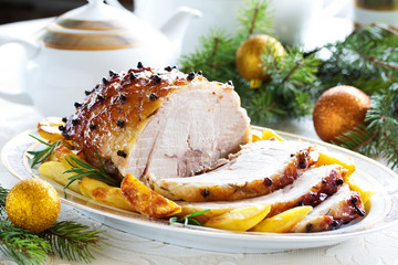 Roast pork with orange glaze, decorated with cloves.