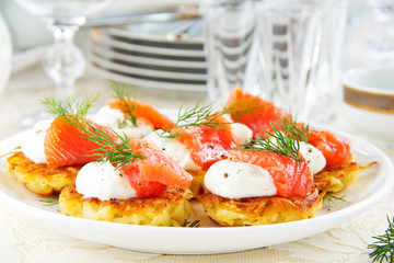 Appetizer of hash browns and red fish.