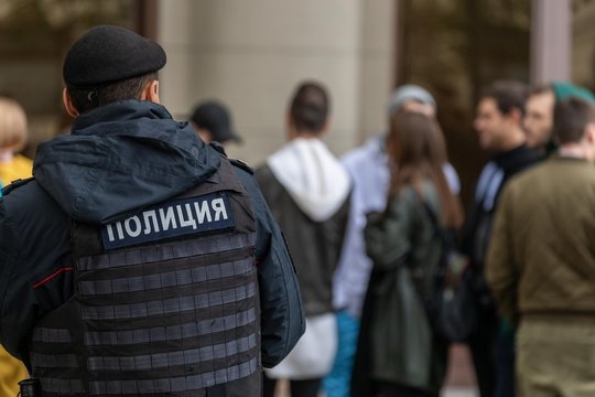 Russian policeman watches a group of people