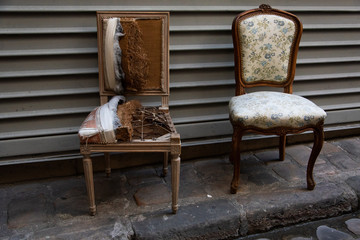 Torn broken armchair and restored one. Renovation concept. 