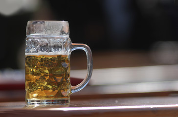 Abandoned empty beer mug, no foam, on beer garden table. 