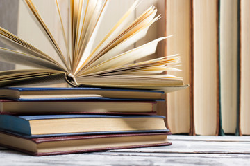 Open book, hardback books on wooden table. Back to school. Copy space