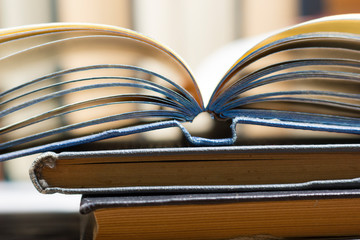 Naklejka premium Open book, hardback books on wooden table. Back to school. Copy space