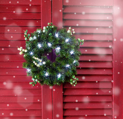 Christmas wreath on a red wooden shutters. - 290691435
