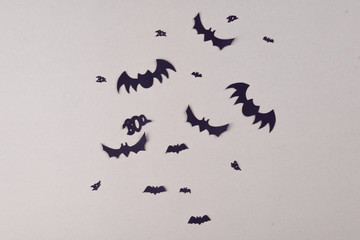 Halloween party content. Black bats of different sizes on a plain background.
