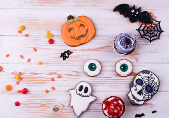 Fototapeta na wymiar Halloween party content. Halloween gingerbread cookies on a wood background.