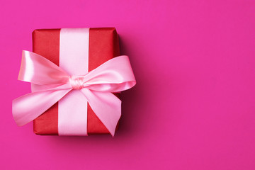 Gift box on a beautiful background with a satin ribbon. Holiday concept