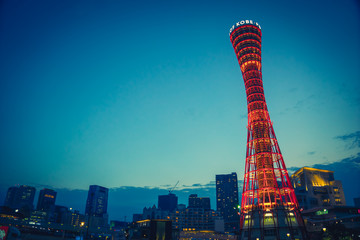 Skyline and Kobe Port Tower lighten up at Sunset - obrazy, fototapety, plakaty