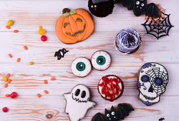 Halloween party content. Halloween gingerbread cookies on a wood background.