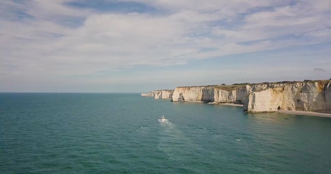 Drone footage of a yacht sailing off the Normandy coast towards the famous Etretat cliffs 
