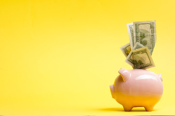 Piggy bank isolated on yellow background. Savings concept - 290695212