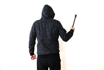 Criminal with crowbar near the doors. Robber in dark hoodie.