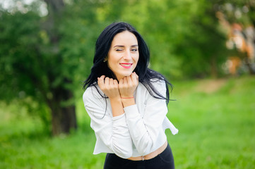 Portrait of a beautiful young woman in a white T-shirt with black hair. joy and laughter...