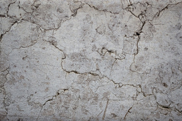 Rough textured stone surface with cracks, closeup
